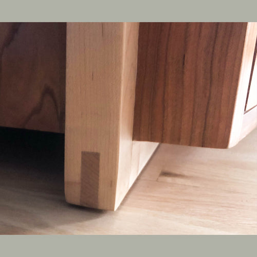 Maple leg detail of bowfront cherry dresser with spalted maple and wenge accents