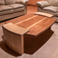 Coffee table of solid cherry and maple with suspended center