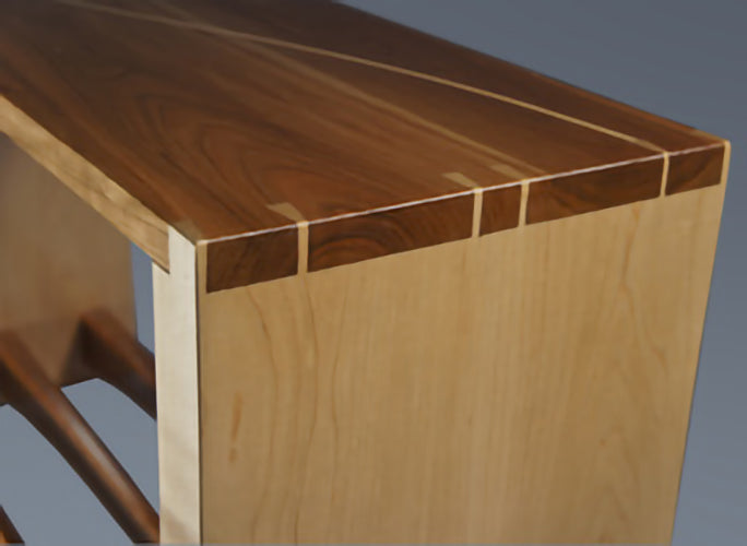 Closeup of bench dovetailed joints and Maple inlay