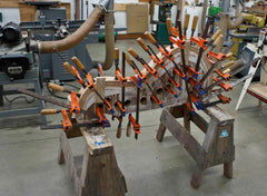 uprights of sculptural music stand during the building process showing glue-up of laminated layers