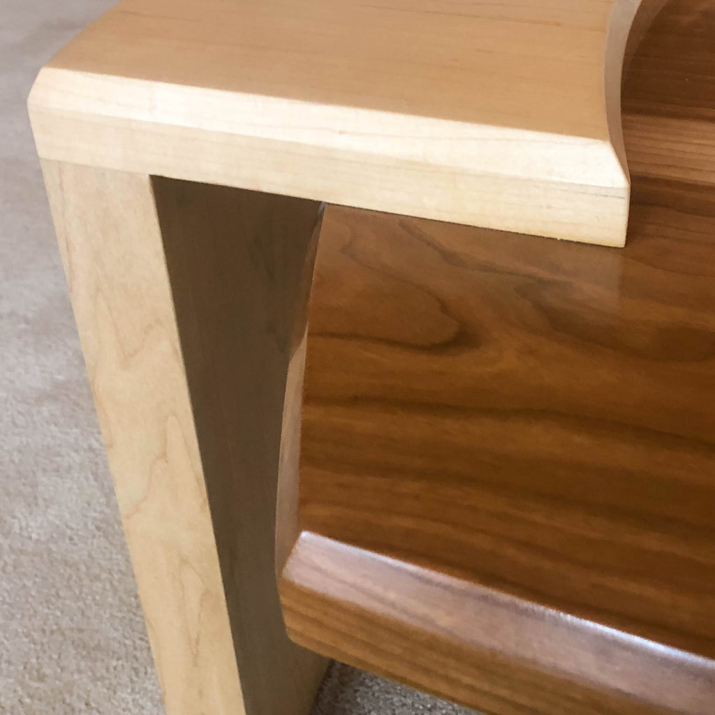 detail of Coffee table of solid cherry and maple with suspended center