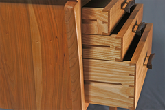 detail of cherry nightstand  dovetailed drawers and handles